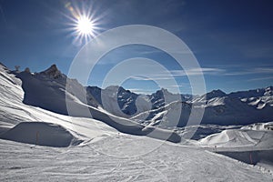 Snowfield and snow covered high alpine mountain peaks