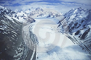 Snowfield in valley between snow-covered mountains photo
