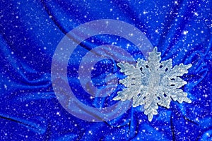 Snowflake on a blue silk with sparkles