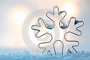 Snowflake cookie cutter on blue snow