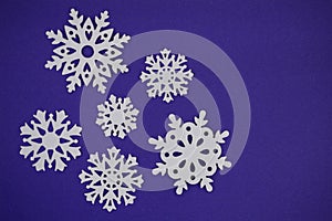 Snowflake cut outs on blue purple background