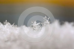 Snowflake. Macro photo of real snow crystal. Beautiful winter background seasonal nature and the weather in winter.