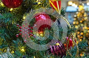 Snowflake with red rhinestones on the Christmas tree with Christmas balls and garlands.