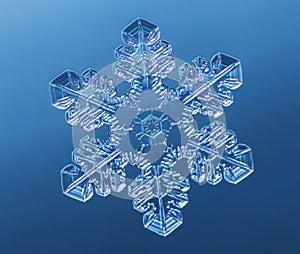 Snowflake on smooth gradient background. Macro photo of real snow crystal on glass surface. This is small snowflake with