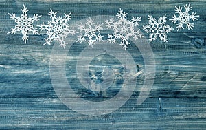 Snowflakes border over rustic wooden background. winter holidays