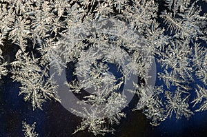 Snowflakes frost rime macro on window glass pane