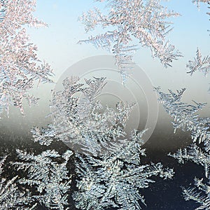 Snowflakes frost rime macro on window glass pane