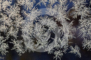 Snowflakes frost rime macro on window glass pane