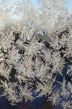 Snowflakes frost rime macro on window glass pane