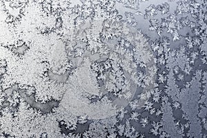 Snowflakes and ice on frozen window