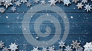 Snowflakes and snowflakes on blue wooden background. Ideal for winter-themed designs and holiday