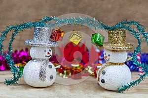 Snowflakes are on a wooden floor with a gift box on the head.