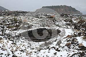 Snowing on Angelo Cave, on background Egitto Mount in Etna Park photo