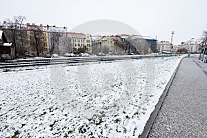 Snowing day on Prague. People walk on Park Letna while tram travel through the city, close to Hradcanska in Prague 6