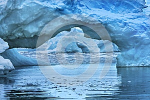 Snowing Floating Blue Iceberg Arch Reflection Paradise Bay Skintorp Cove Antarctica