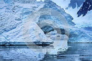 Snowing Floating Blue Iceberg Arch Reflection Paradise Bay Skintorp Cove Antarctica