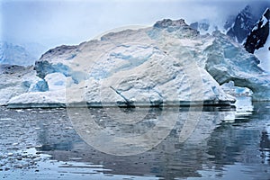 Snowing Floating Blue Iceberg Arch Reflection Paradise Bay Skintorp Cove Antarctica