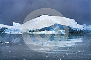 Snowing Floating Blue Iceberg Reflection Paradise Bay Skintorp Cove Antarctica