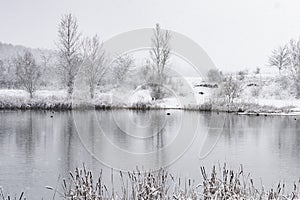 Snowing on a lake in winter