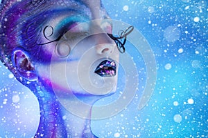 Snowing photo of beauty woman with closed eyes and creative body