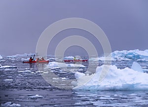 Snowing Red Kayaks Iceberg Blue Glacier Paradise Harbor Antarctica