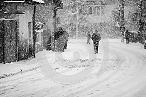 Snowing urban landscape with people