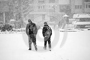 Snowing urban landscape with people