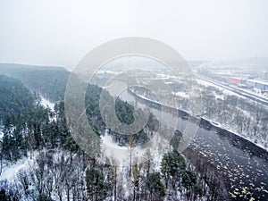 It is snowing in Vilnius, Lithuania, aerial top view of Neris river