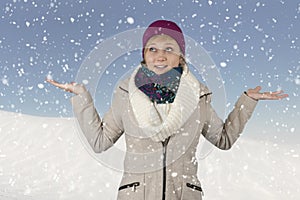 Snowing on a young woman with hat and scarf