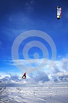 Snowkiting man jumps on board to sky