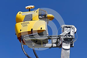 Snowmaking on blue background. Yellow Snow cannon in Carpathian Mountains, Romania