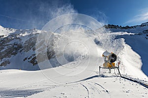Snowmaking - snow cannon working on the slope