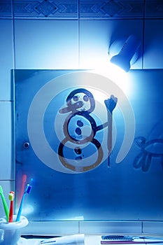 Snowman on the bathroom mirro. Drawing on Mirror.