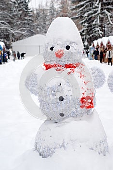 Snowman at Christmas fair with kiosk