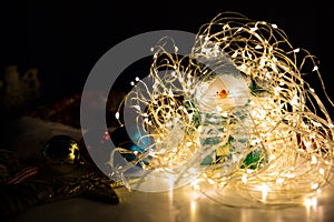 Snowman and Christmas lights and garland decorations. New Year festive background. Presents, gifts, greeting postcard for winter