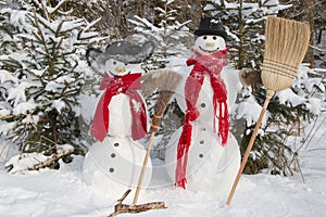 Snowman couple in winter - christmas outdoor decoration with snow