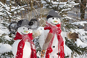 Snowman couple in winter - christmas outdoor decoration with snow