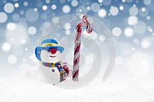 Snowman doll with candy cane