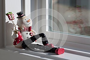 Snowman doll in the window