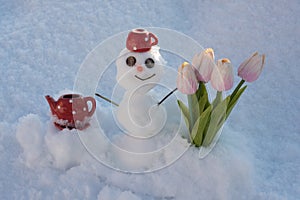 Snowman with flowers. Spring winter snow man with coffee cup.