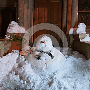 Snowman in front of doorway