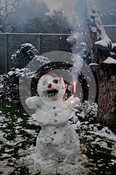 snowman with the grimace of a crazy brawler fan. lighted