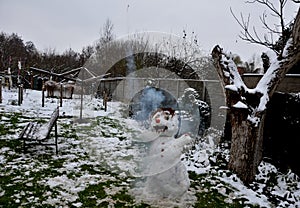 snowman with the grimace of a crazy brawler fan. lighted