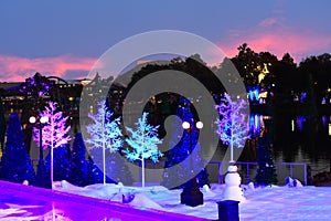 Snowman and Holiday Trees on colorful sunset background in International Drive area.