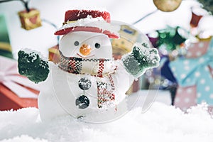 Snowman and light bulb stand among pile of snow at silent night, light up the hopefulness and happiness in Merry christmas and hap