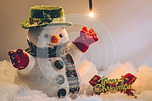 Snowman and light bulb stand among pile of snow at silent night, Merry christmas and Happy new year night.