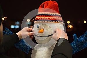 Snowman at night. Making a snowman.