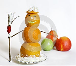 Snowman from oranges with broom and cream