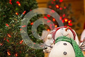 Snowman Ornament Surrounded By Red Christmas Lights