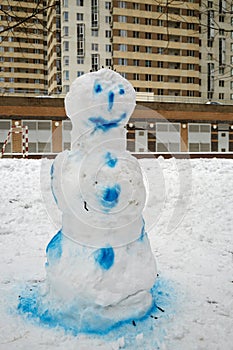 Snowman painted in blue colour in the courtyard of photo